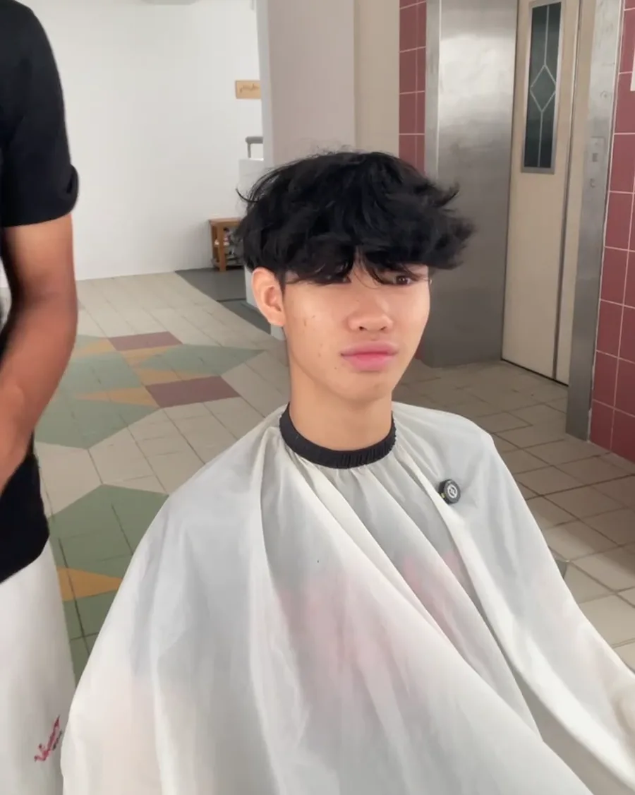 Client in the chair under a barber's cape